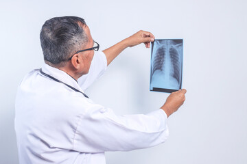 Senior Asian Doctor Examining Radiological Chest X-ray Film for Medical Healthcare Hospital Service