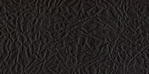 Crumpled Black Paper Textured Background. Grunge Texture with Creases and Wrinkles