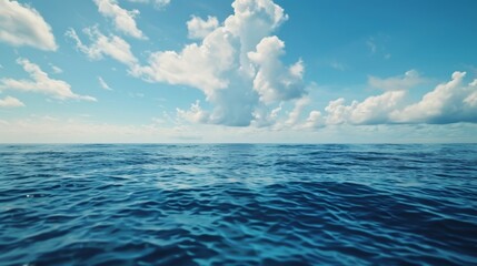 Fototapeta premium A vast expanse of water stretches under a sky filled with thick clouds, creating a moody and dramatic scene. The water appears calm yet vast, reflecting the somber tones of the sky above.