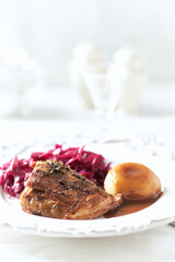 Fried pork ribs with potato dumplings on bright background. Close up.	