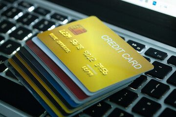 Several credit cards placed on a notebook computer keyboard To pay and pay for goods through credit...