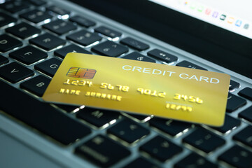 Credit cards placed on a notebook computer keyboard To pay and pay for goods through credit cards,...