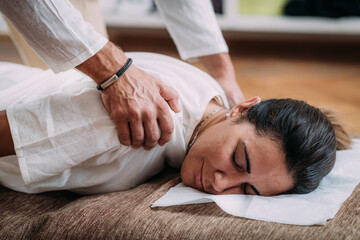 Shiatsu Arms and Shoulder Massage. Therapist Massaging the Small and Large Intestine Meridians. - 794757224