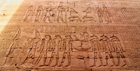 Wall art bas relief of Ptolemy IX Soter II leading the procession of Horus in the sacred barque in...
