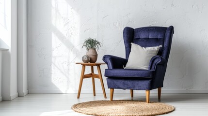 A simple, white-walled living room with a plush blue armchair provides a cozy and inviting space for relaxation.