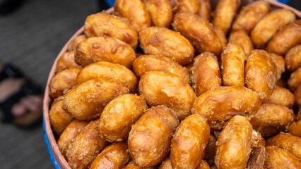 Indonesian traditional cake called gemblong. made by steam sticky rice coated by brown sugar