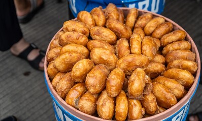 Indonesian traditional cake called gemblong. made by steam sticky rice coated by brown sugar