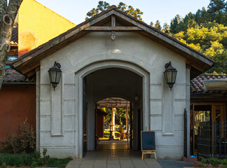 wooden entrance to the church with two lights at every side of the door.