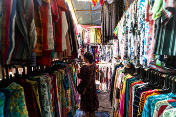 Happy young Indian woman shopping from Anjuna flee market in Goa, India 
