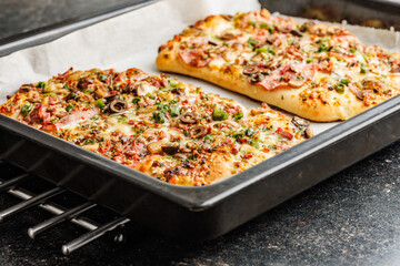 Tasty italian square pizza on kitchen table. - 794764061