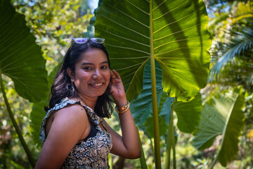 Beautiful young Indian woman laughs cheerfully while standing against the background of exotic...