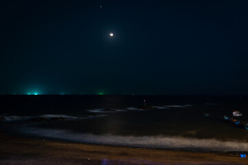 Long exposure of Goa beach with moon