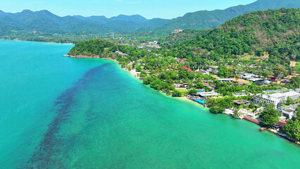 Beaches kissed by turquoise waves, resorts nestled along the shore, emerald forests embracing...