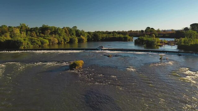 Push in and pan move of aerial footage of white 4WD crossing, Ivanhoe crossing in Kununurra, Western Australia 