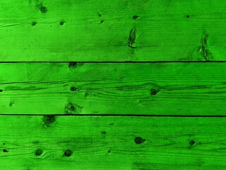 New green wooden plank natural knots pattern background. Salad green modern color wooden wall, floor with knots. Dry grained grass green wooden knotted table board. Seamless grunge rustic wood texture