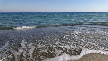 Ocean sea Aegean waters with sandy beach in Greece.