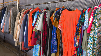 shop specializing in second hand clothing store sale of women clothing with a carrier full of trendy girls clothes