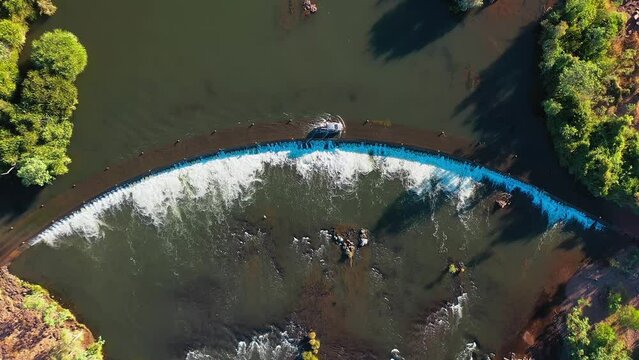 Birds eye view aerial footage of a white 4WD crossing, Ivanhoe crossing in Kununurra, Western Australia 