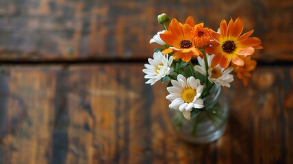 Photo taken from above. flower in a vase on the wooden table