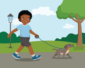 Cute little African boy walking the dog at the park