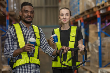 Happy worker  having a coffee break in Warehouse. Warehouse  worker people having a conversation in a workplace with cups of coffee. Cheerful work team during break time in Inventory site.