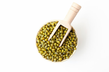Uncooked, green mung beans in bowl on white background. Dry mung beans grains. Top view