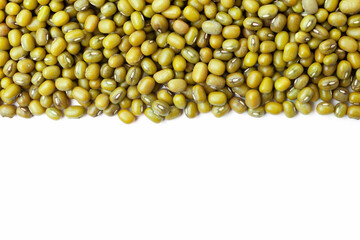Uncooked, green mung beans border on white background. Copy space for text. Top view