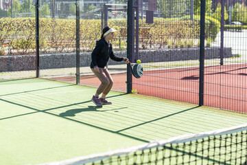  Young girls playing padel on a sunny day