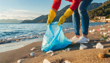 Beach Cleanup. Woman Collecting Garbage in Plastic Bag by the Seashore on Earth Day