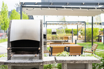 Closeup view of opened barbecue grill at outdoor patio 