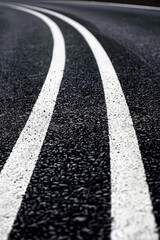 black asphalt road and white dividing lines
