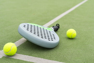 Paddle racket, next to the ball and on a carpet of the play area - 794854412
