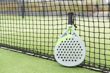 Paddle racket, next to the ball and on a carpet of the play area - 794857461