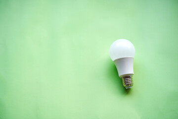 A light bulb in a green background. Concept of sustainable energy, environmental.