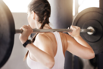 Gym, fitness and woman with barbell for training, exercise or workout, progress and body...