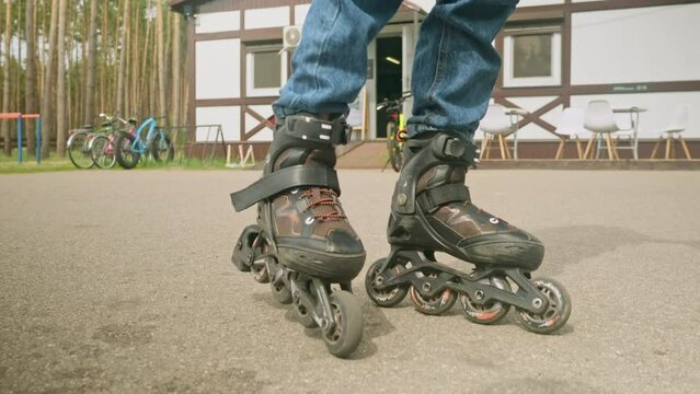 Close-up. legs of a roller skater are rollerblading on street asphalt pavement.