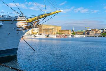 The historic Af Chapman, a full-rigged ship, is moored in Stockholm harbor with city buildings,...