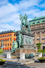 Fototapeta na wymiar The statue of Gustav II Adolf is captured here standing proudly in Stockholm, Sweden, with clear skies and surrounded by the city architecture.