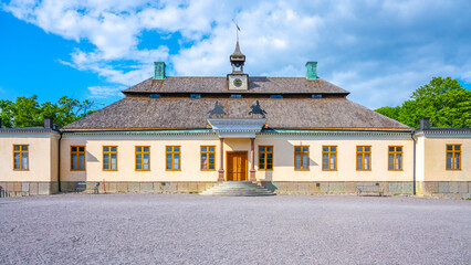 Skogaholm Manor stands proudly under a bright blue sky, showcasing its traditional Swedish...