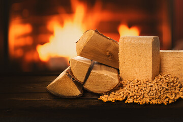 biomass heating. firewood, pellets and briquettes on wood burning fireplace background. sustainable, carbon neutral and renewable fuel