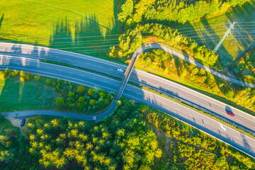 Aerial View of Highway Bridged by a Bicycle Path. Overhead view showcasing the convergence of...