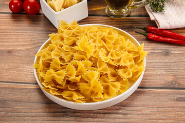 Raw dry Italian pasta - farfalle - 794897676