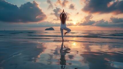 Lifestyle image of a young woman practicing yoga on a peaceful beach