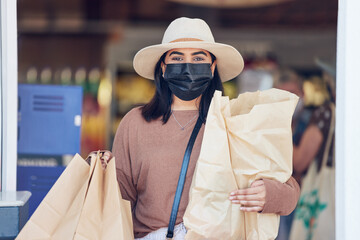 Woman, face mask and shopping bag at store with sale, discount and budget with retail safety and...