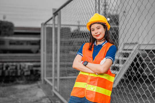 portrait young women worker standing happy smile with safety hardhat. smart employee lady working in industry.