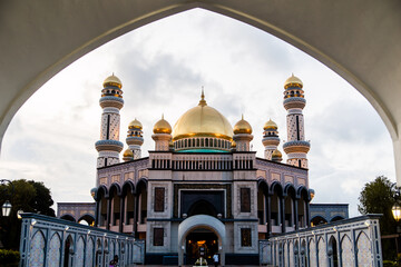 view of the gold domes of Jame' Asr Hassanil Bolkiah Mosque through an archway in Brunei Darussalam...
