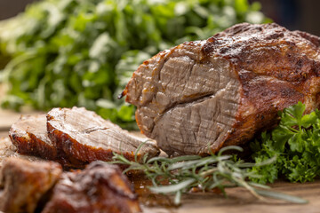 Juicy whole roasted pork neck on a cutting board - 794920032