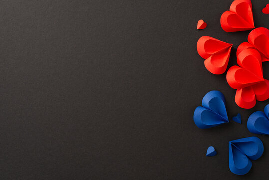 Juneteenth tribute: hearts in red and blue on black backdrop, marking freedom from slavery. Top view image invites social text or ad placement