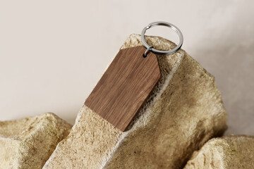 Wooden keyring on a stone mockup. 3D rendering