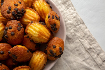 Homemade Chocolate Chip Madeleines on a Plate, top view. Overhead, from above, flat lay.